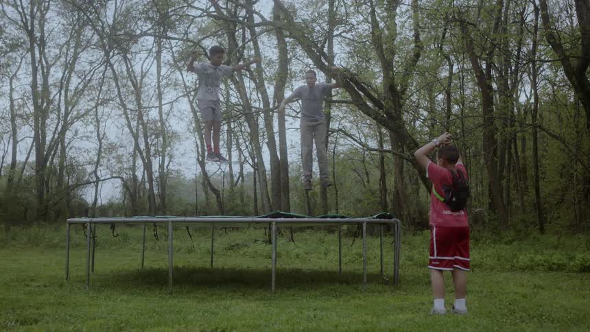 Boys jump on a trampoline