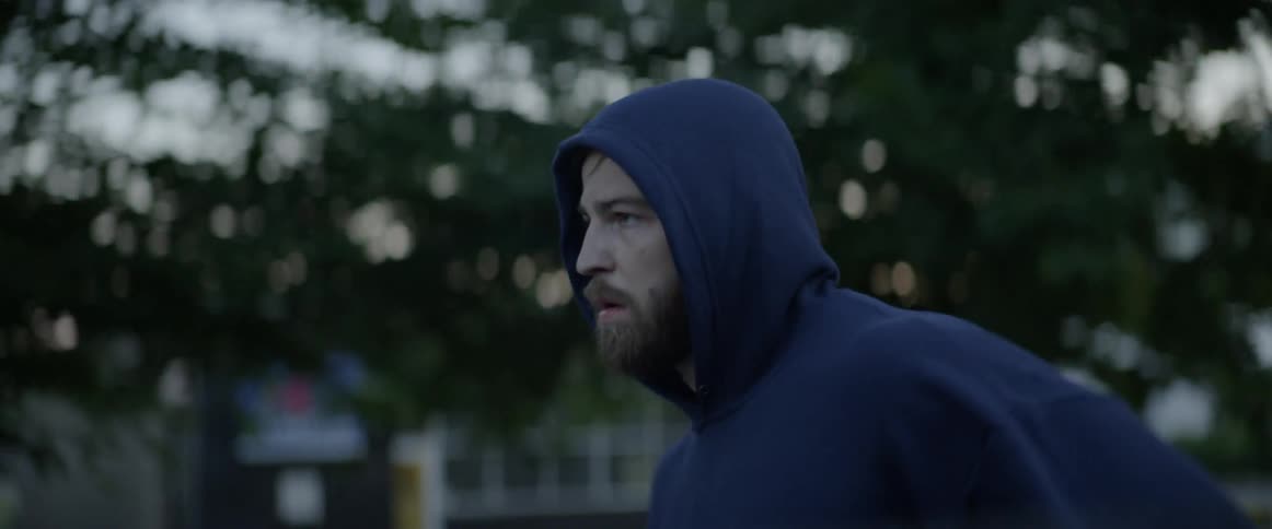 Man jogs outside at dusk
