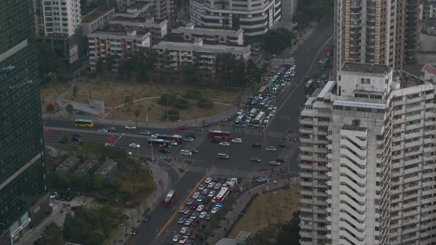 Cars drive on a city street