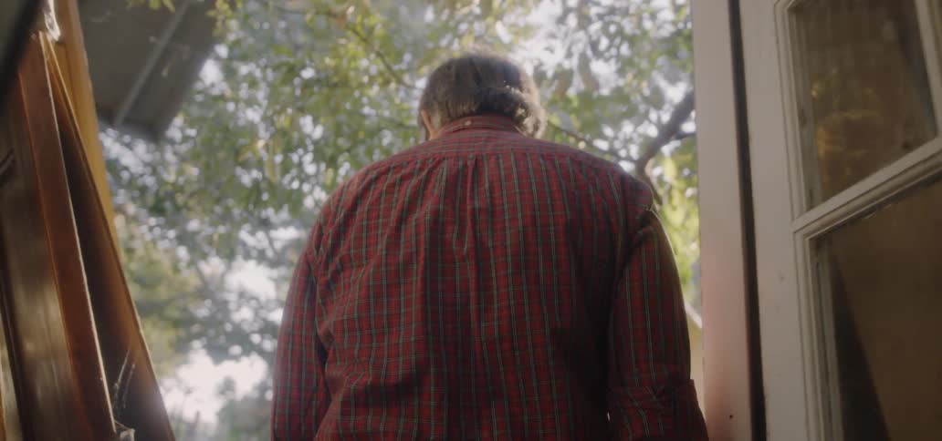 A man walks out into his yard