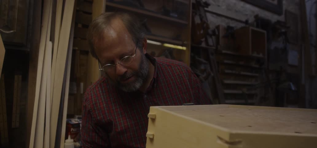 A carpenter works in a workshop