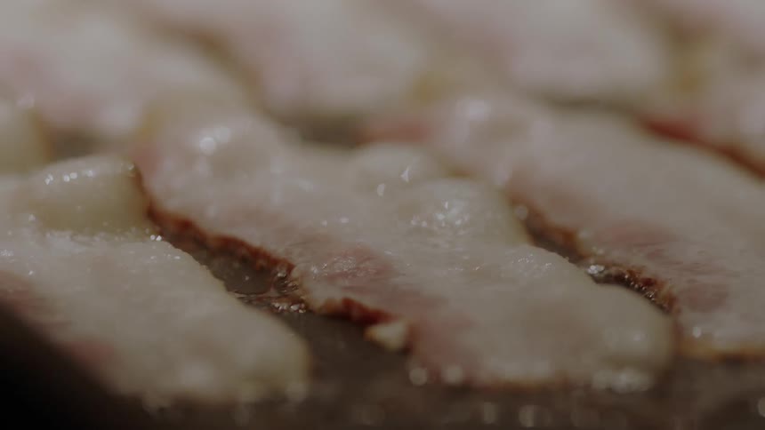 Bacon is sizzling as it cooks