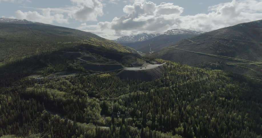 Clouds float above a mountain forest
