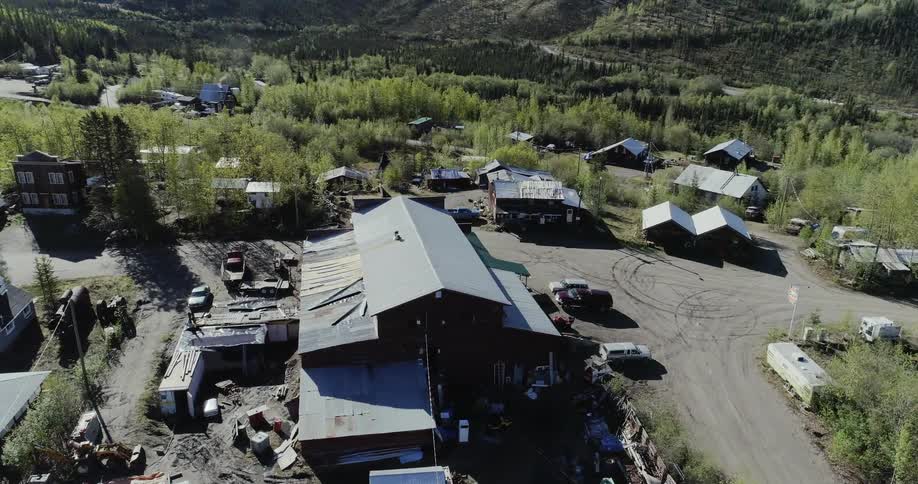 A worksite is full of buildings and vehicles below