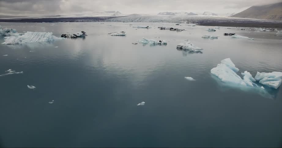 The water is filled with icebergs near the shore