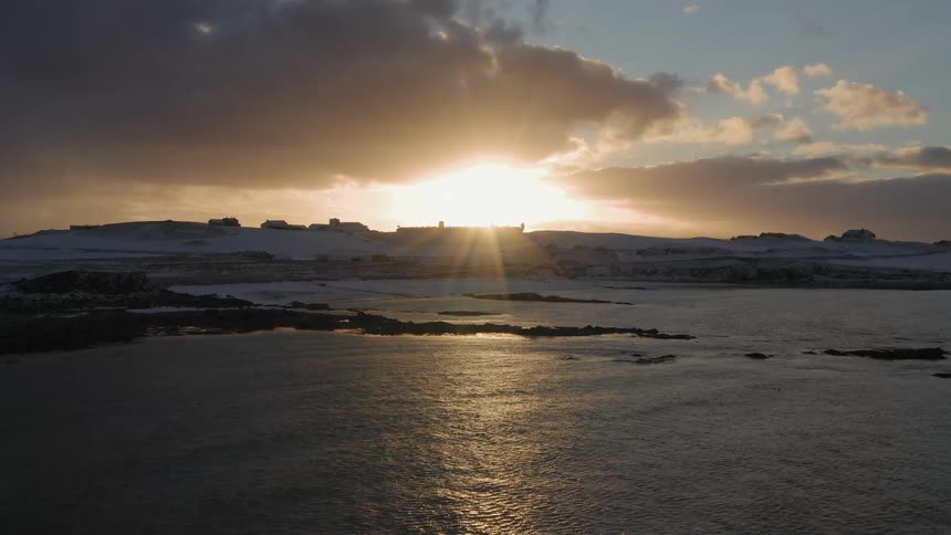 The sun sets over a beach