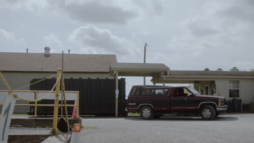 Truck parks next to a building