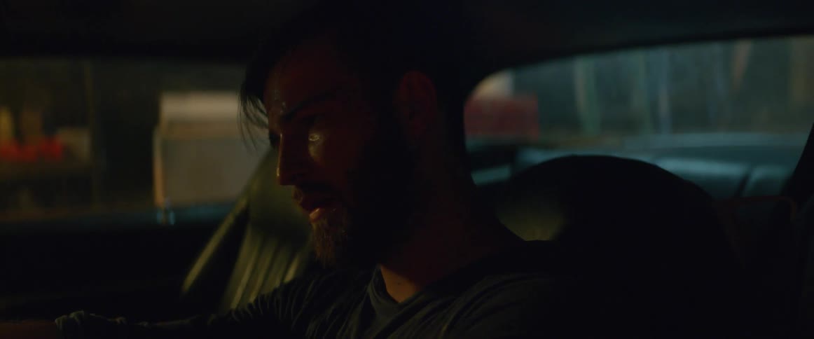 A man cries in a car