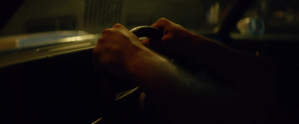 A person grips the steering wheel tight repeatedly