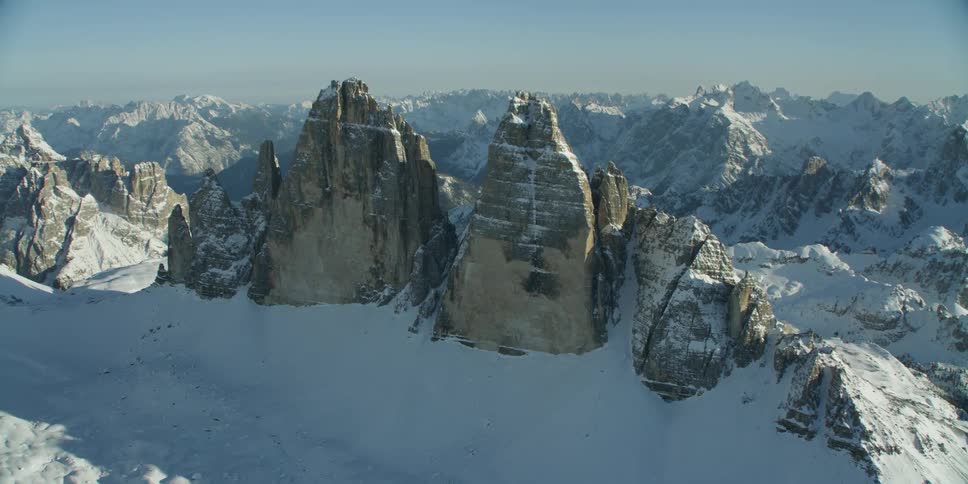 Mountain ridges and rocky peaks in snow on a sunny day