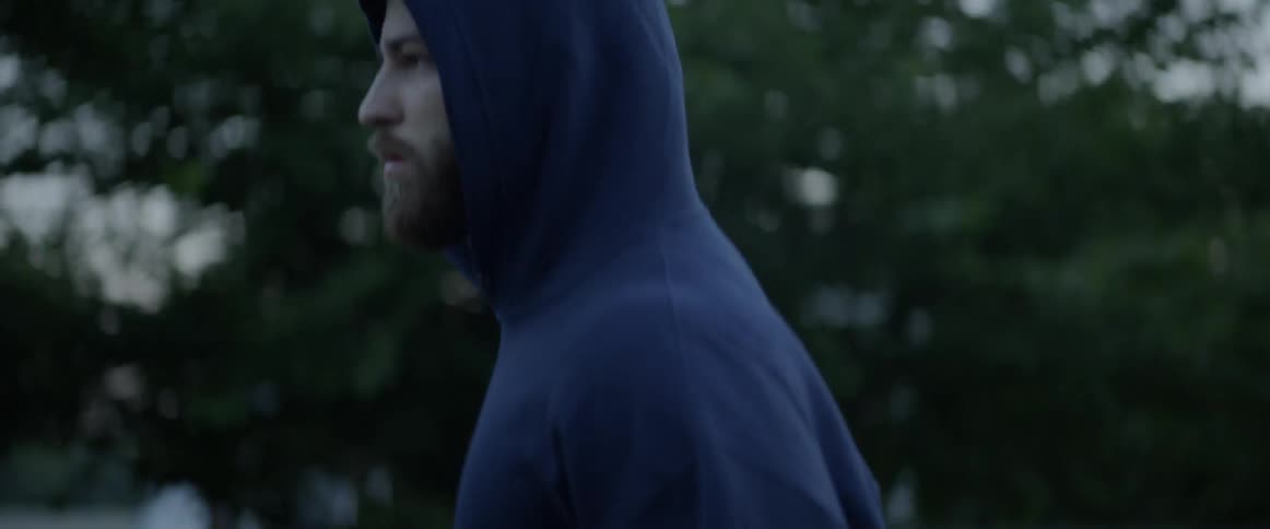 A man is jogging outside on a cloudy day