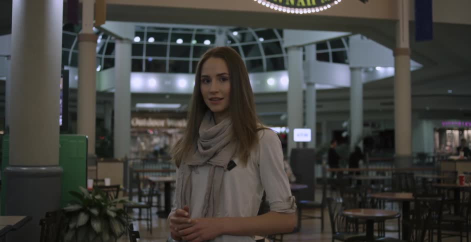 A woman smiles in a airport terminal