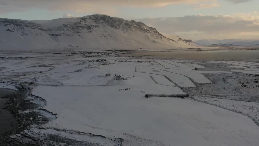 The sun sets over snowy mountains