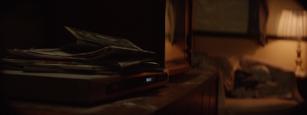 Papers sit stacked on a disc player