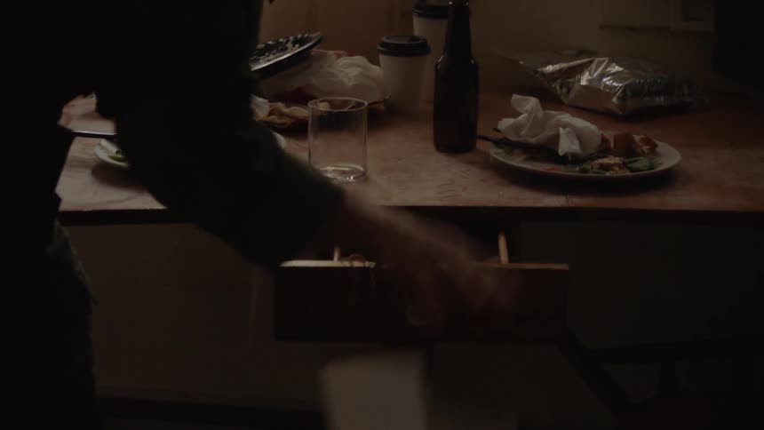Man looks through a small drawer