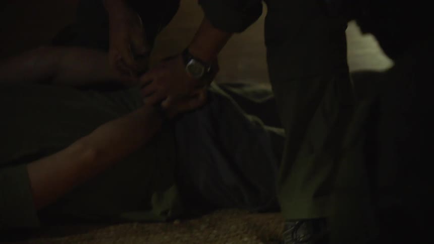 Police handcuff people on the ground