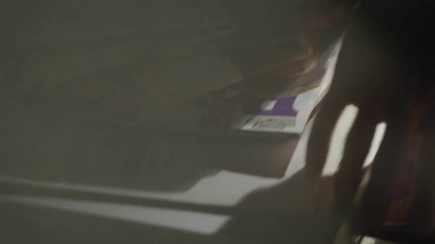 An officer removes a dvd from the tray and puts it in a bag