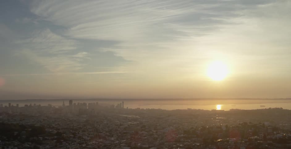 A city is shown from above at dawn