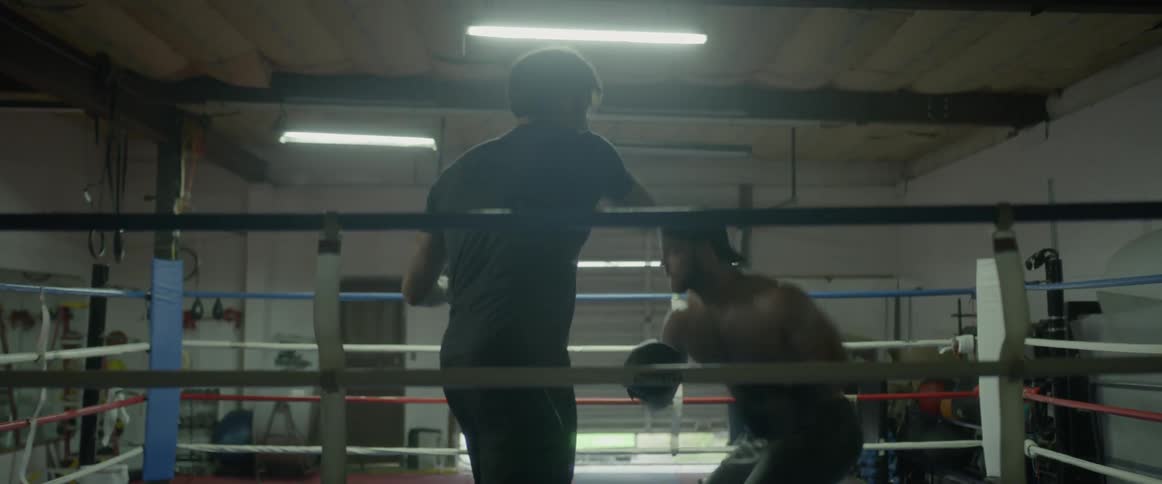 Two men box in a boxing ring