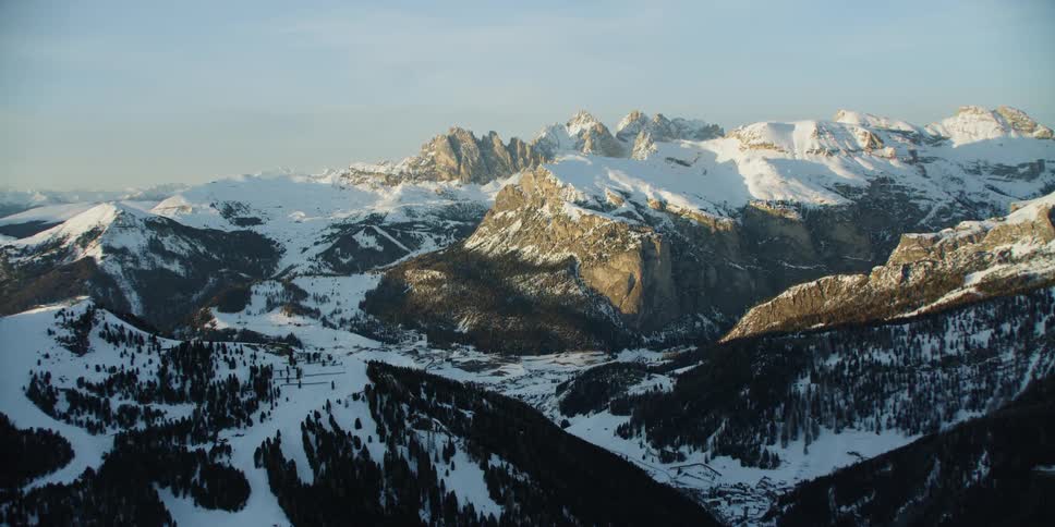 Snow covers mountains at sunset