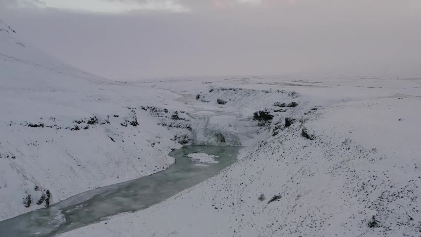 A hiker walks in snowy mountains