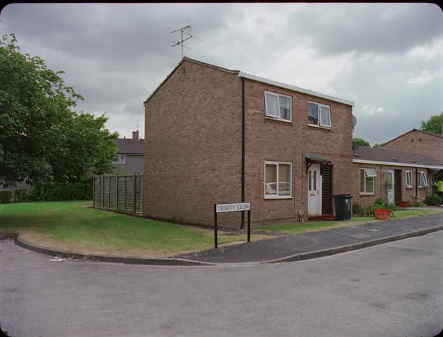 The corner has a tall brick house