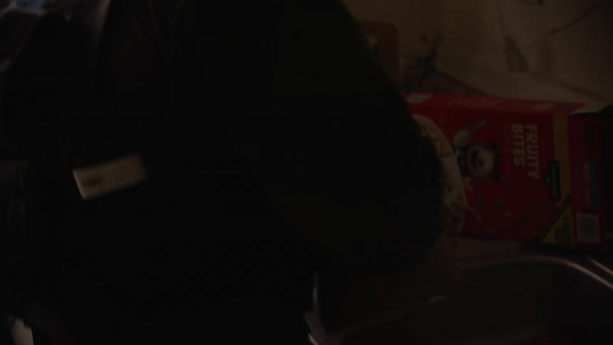 Person in a dim room unpacks a bag