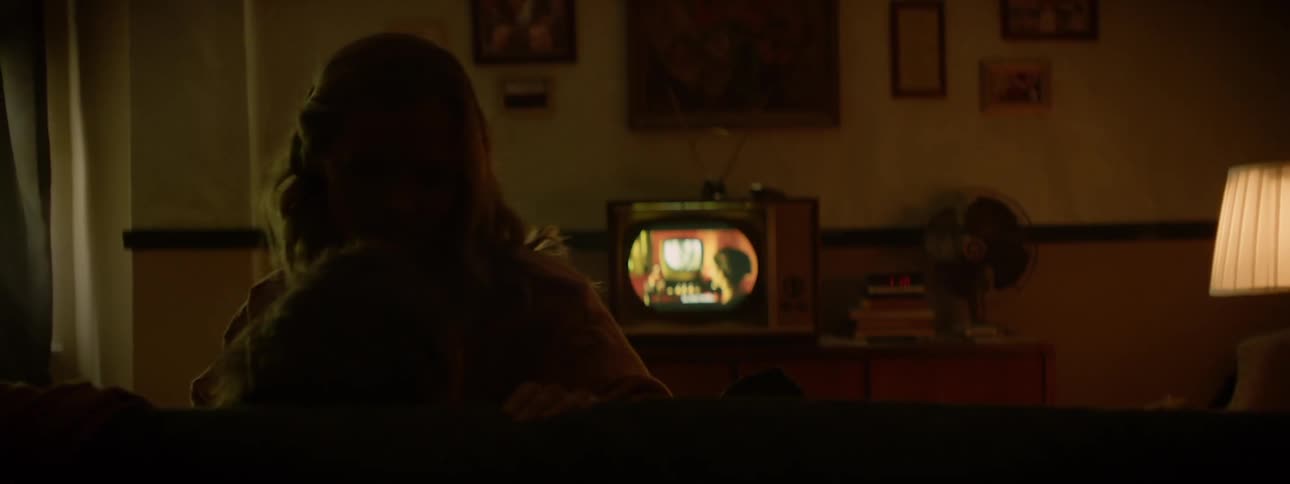 A boy and girl are getting intimate together on a couch
