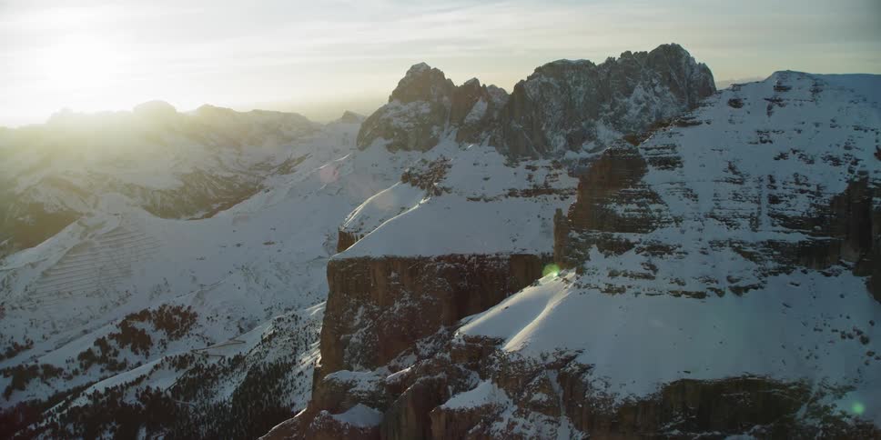 The sun is slowly setting behind the mountain range