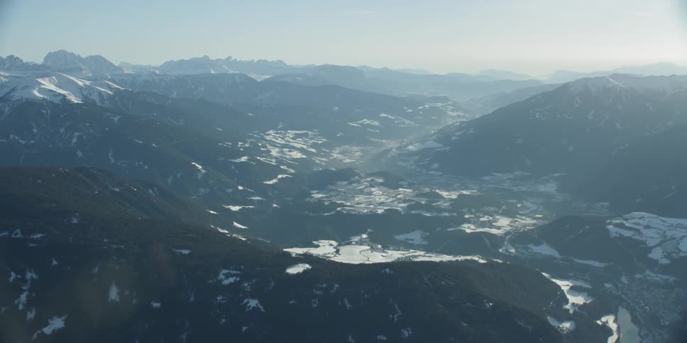 The sun shines over a mountain valley