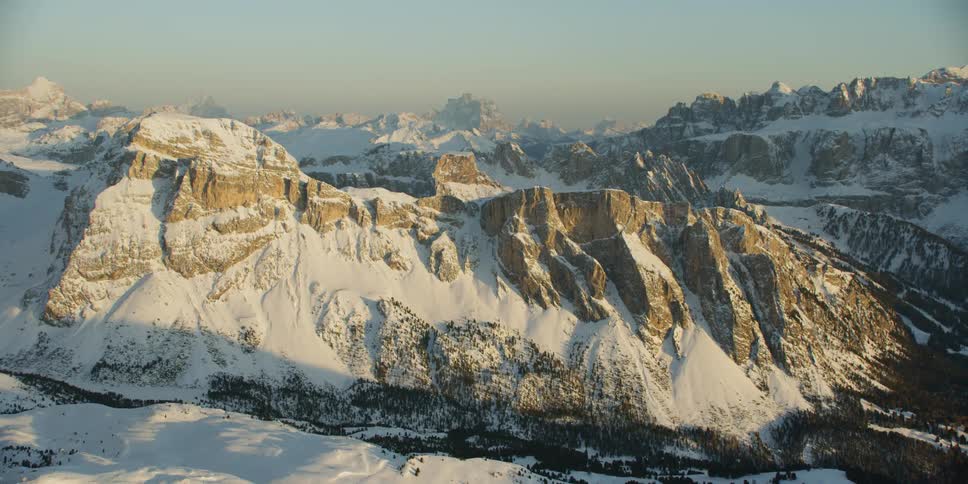 Sun shines over snow capped mountains