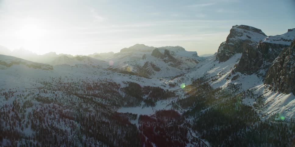 Snow covered mountains sit under a bright blue sky