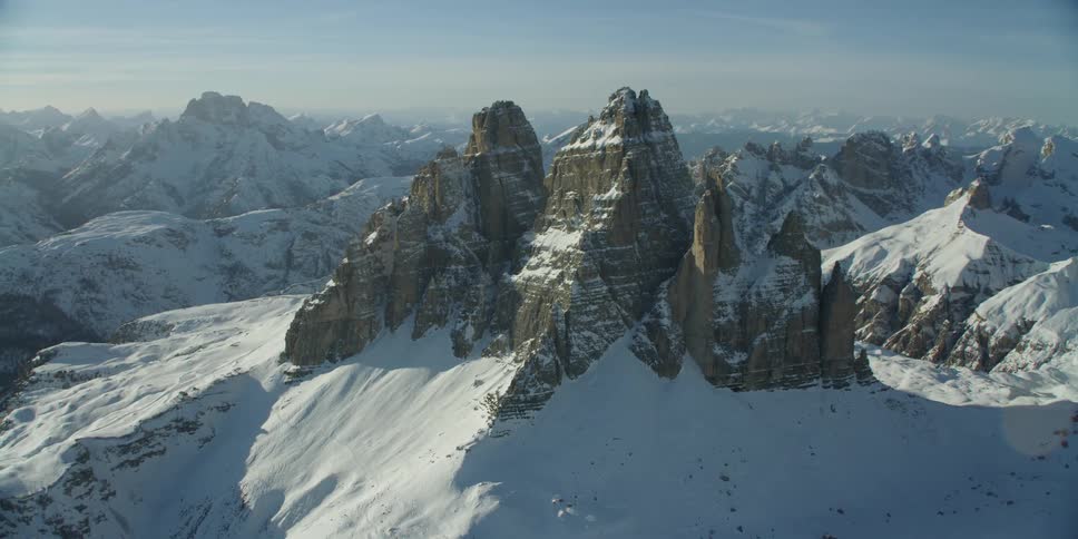 The mountains reach high into the cloudy sky