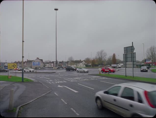 Cars speed through a busy intersection