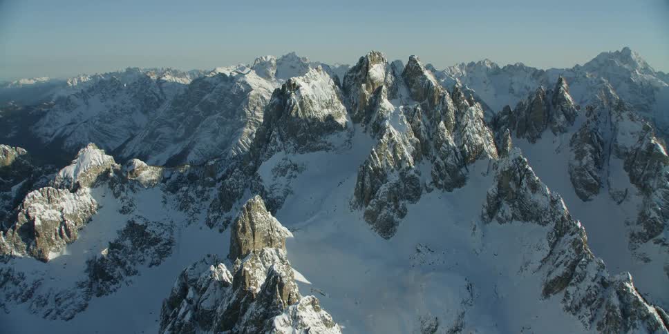 Snow covers rocky mountain peaks