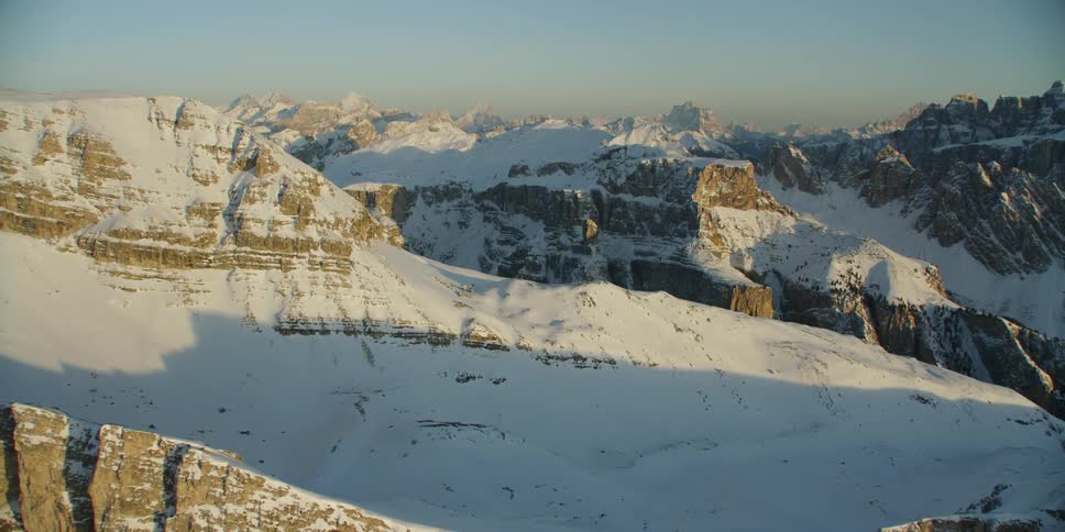 The sun is shining over the large mountain range