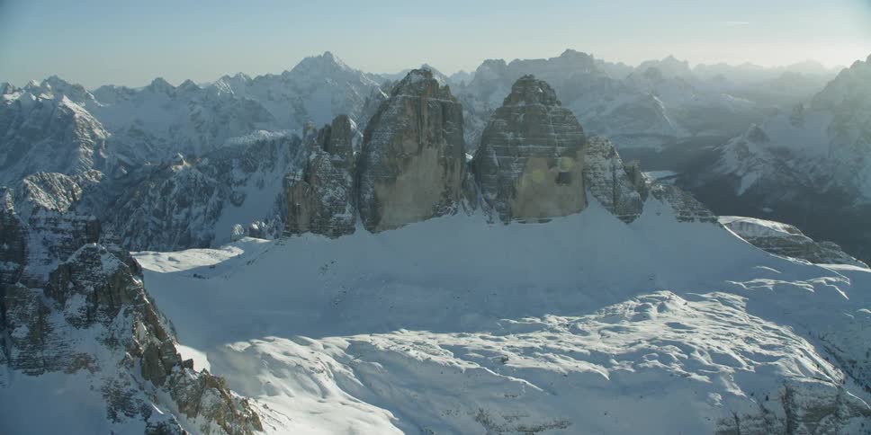 Heavy snow drifts creep up the mountain range