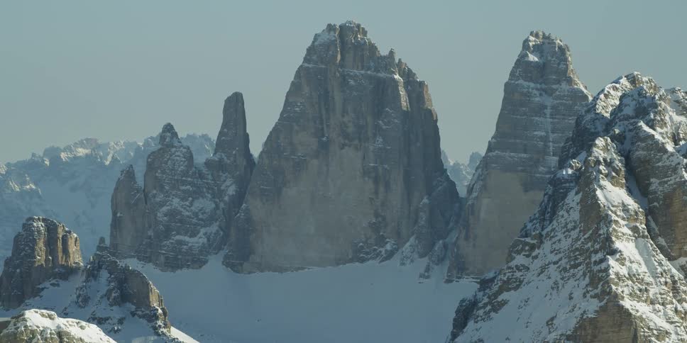 Snow covers rocky mountain peaks