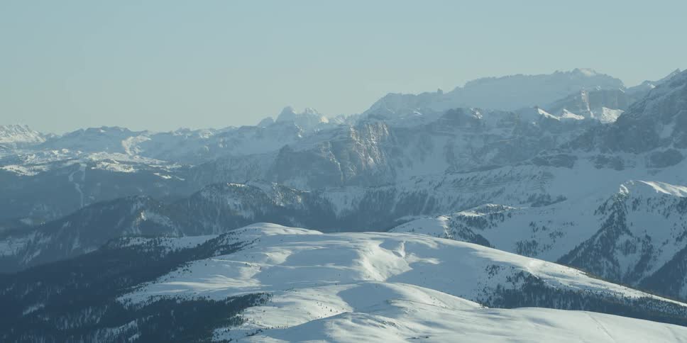 Snow covers mountains on a clear day
