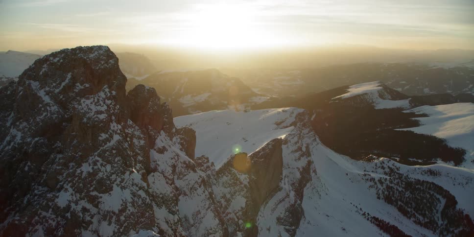 The sun is setting past the mountains ahead