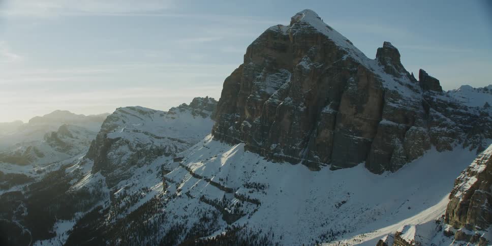 Around the side of the mountain range the sun is rising
