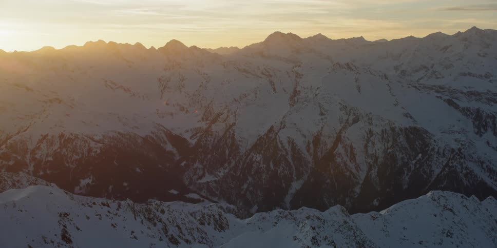 The sun is just setting behind the mountains