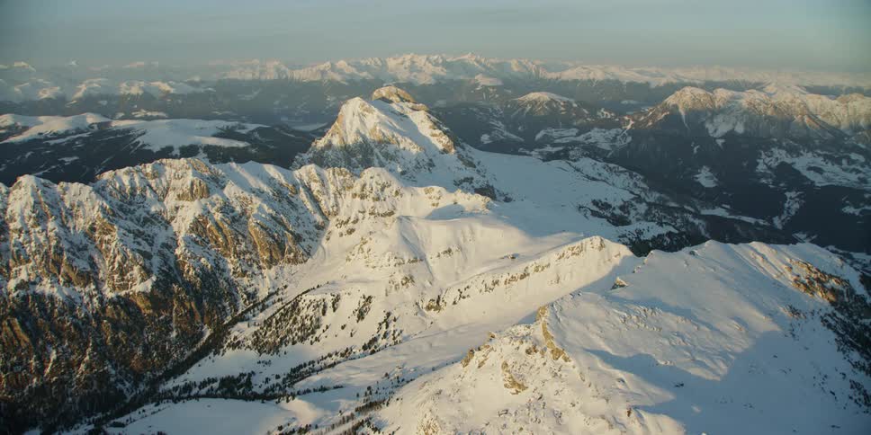 Mountain range covered in snow on sunny day
