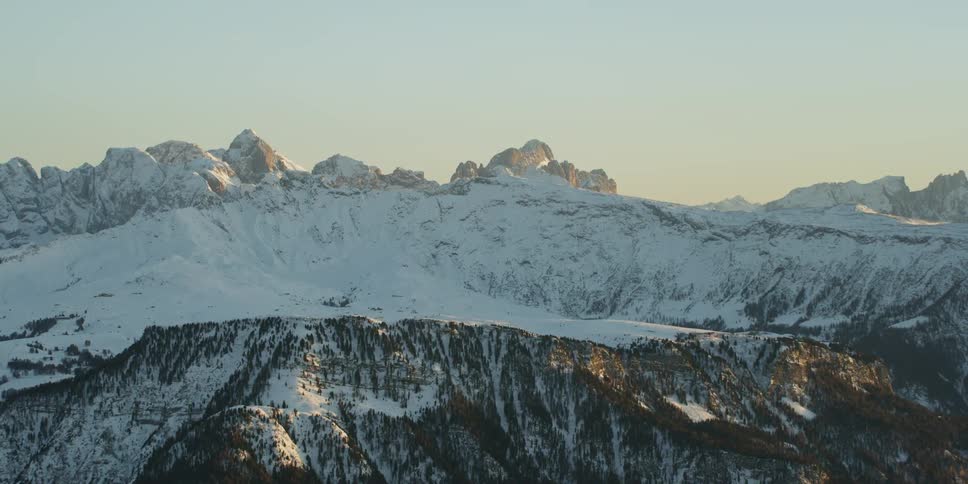 Snow covered mountain range at dawn