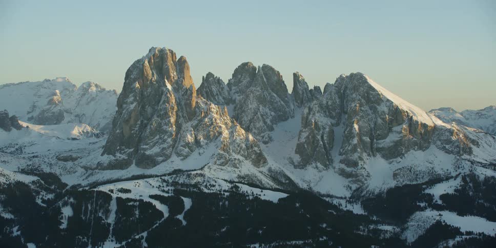 Snow covers rocky mountain peaks
