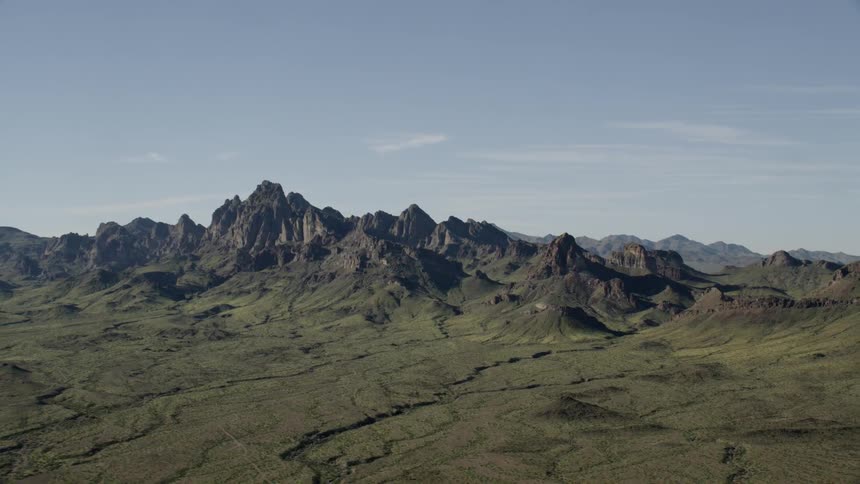 Mountains sit under a blue sky