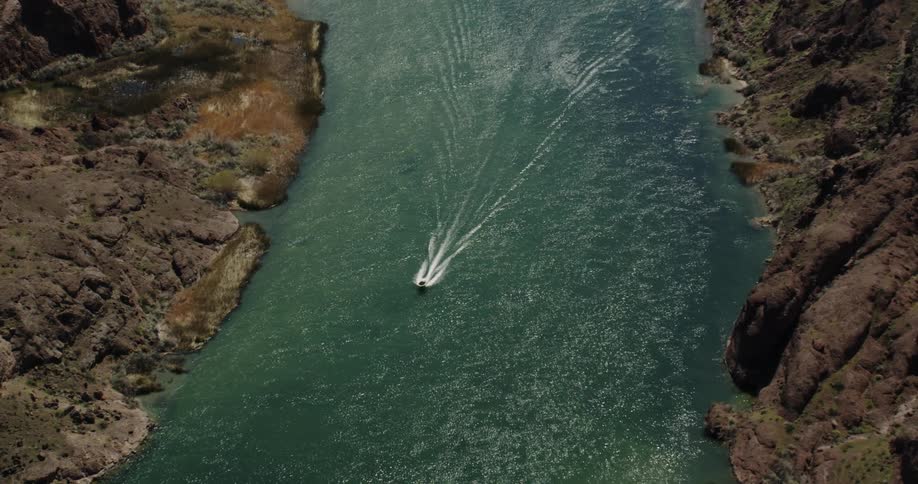 A boat travels down a narrow body of water
