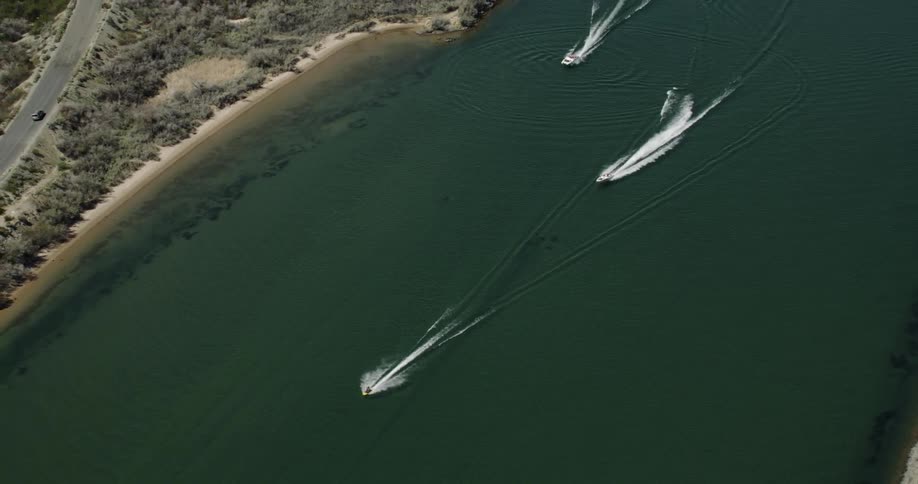 Boats traveling along the coast leave a wake