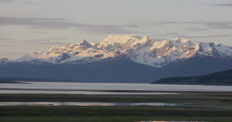 Shadows are covering the base of mountains as morning breaks