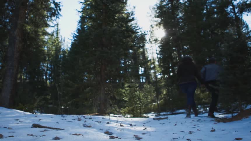 A couple running while holding hands
